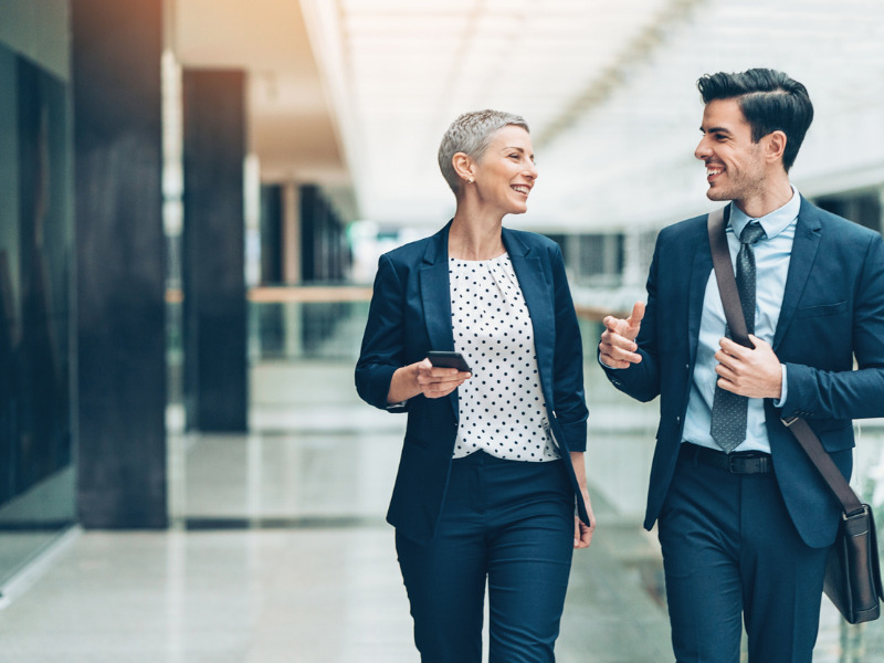 Happy businesspeople walking