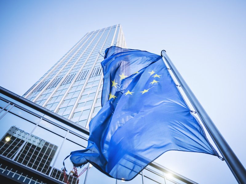 Flag of the European Community in front of the Eurotower in Frankfurt am Main