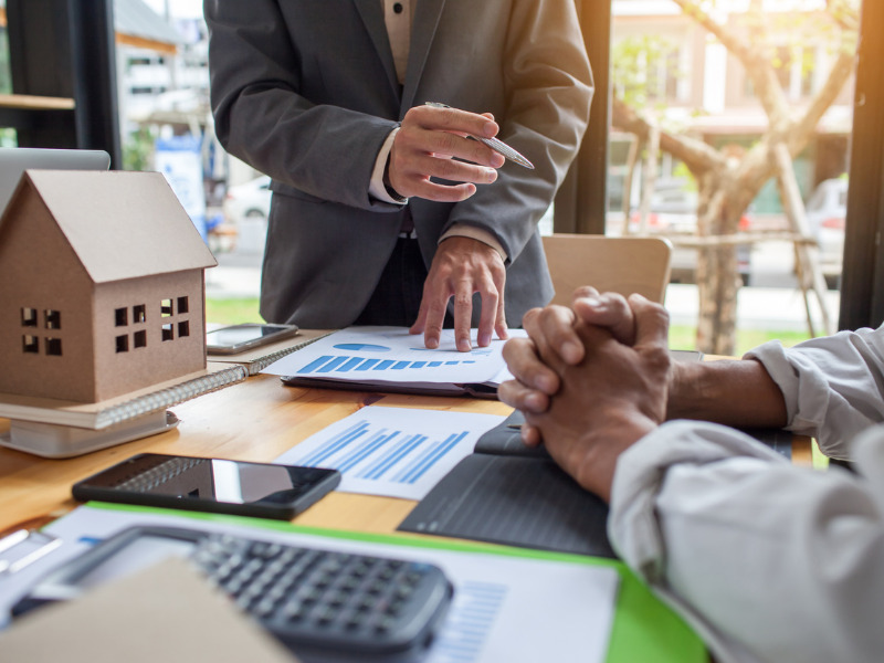 Business meeting around table with real estate broker