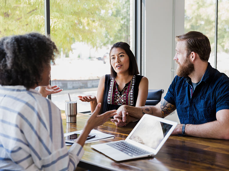 young couple meeting with advisor