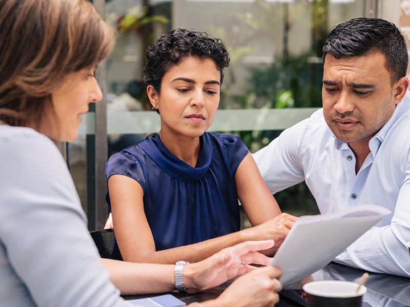 Serious looking couple, ages 40-55, receives financial advice.|||