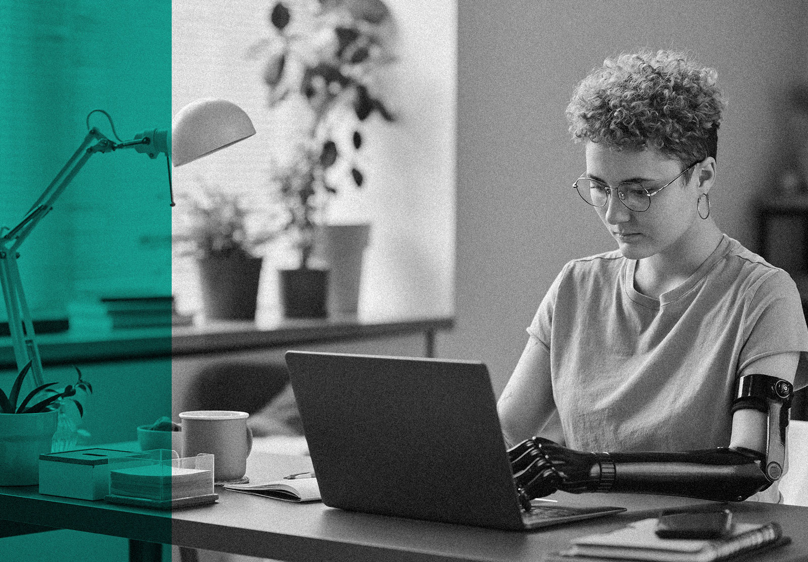 Woman with prosthetic arm working on her laptop