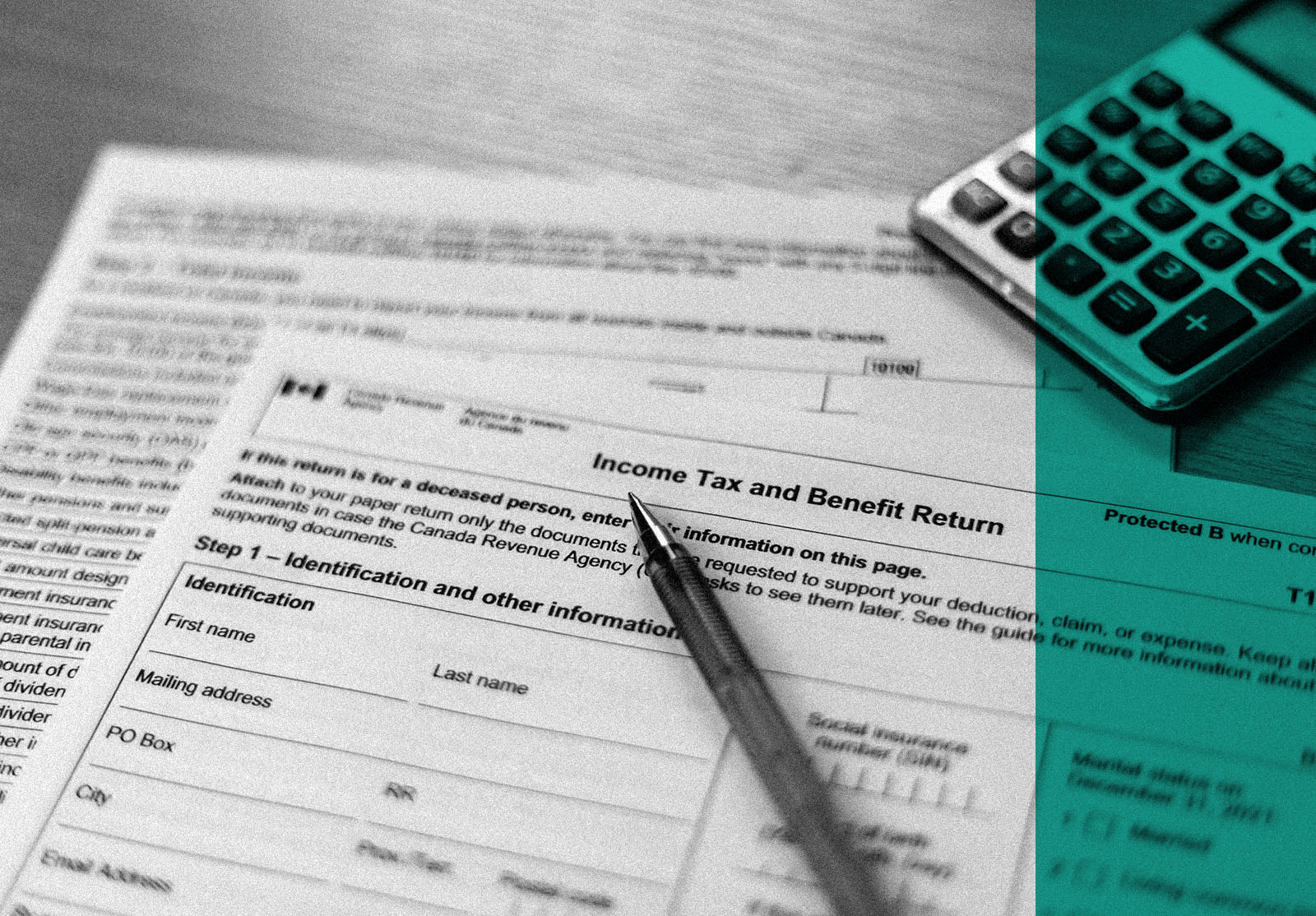 Canadian in come tax and benefit return form with a black pen and a calculator