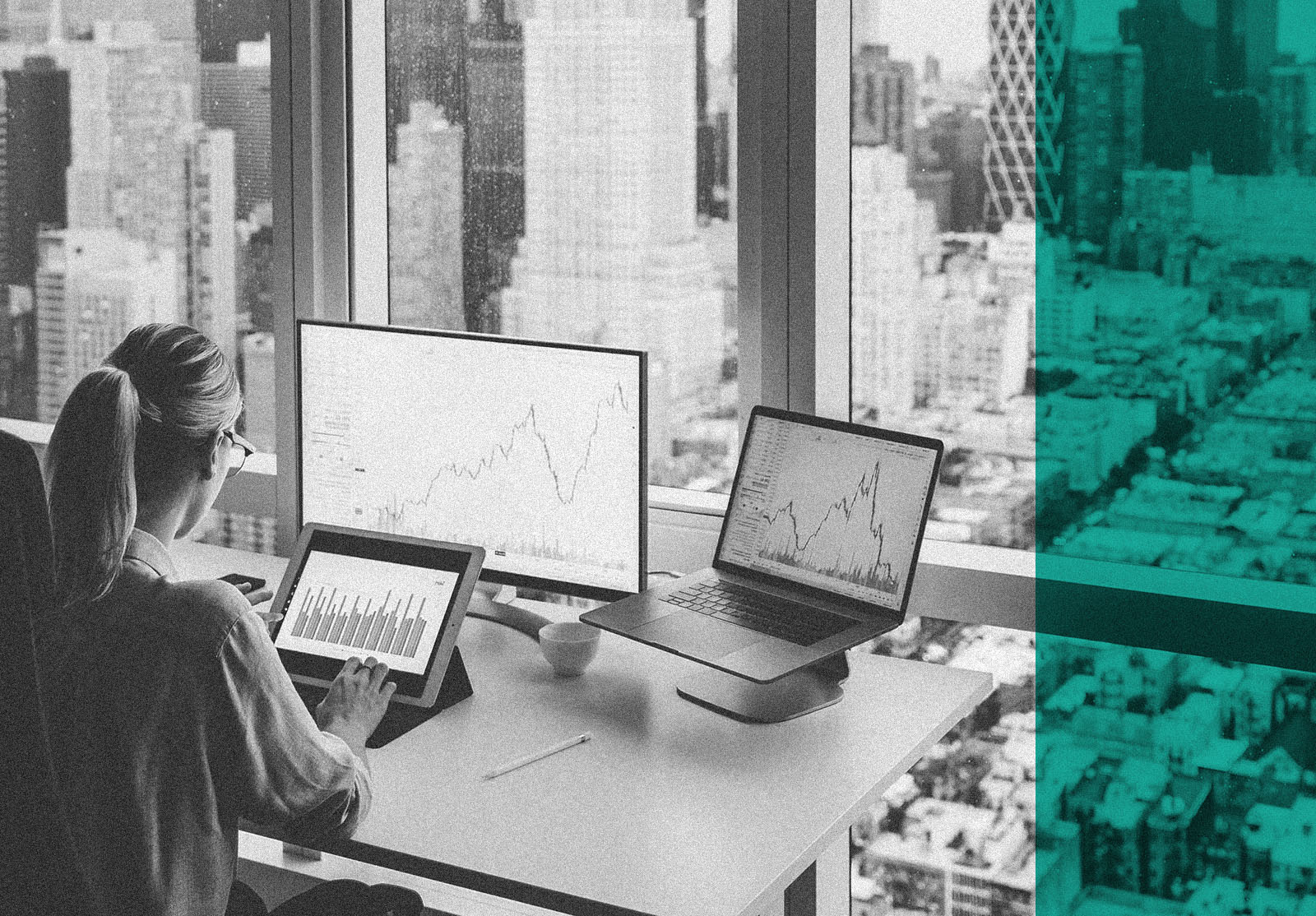 Back view of business woman sitting at panoramic skyscraper office desktop front PC computer with financial graphs and statistics on monitor.Analysis of digital market and investment in block chain