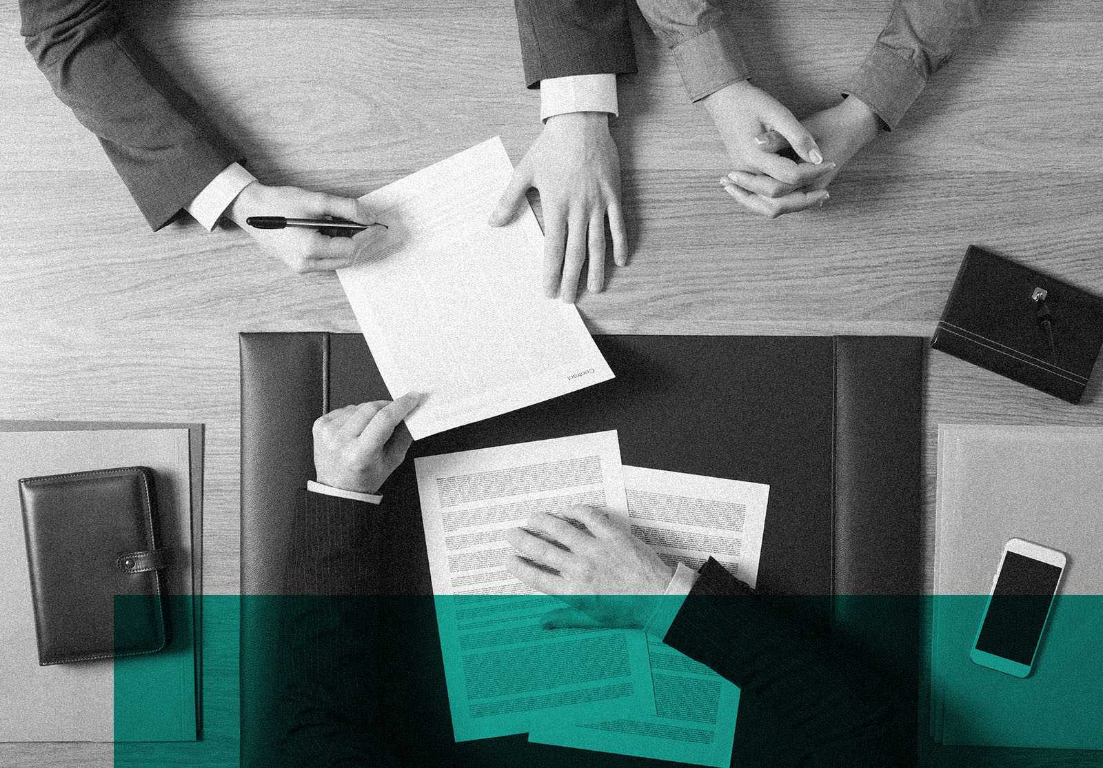 Business man and woman sitting at the lawyers's desk and signing important documents