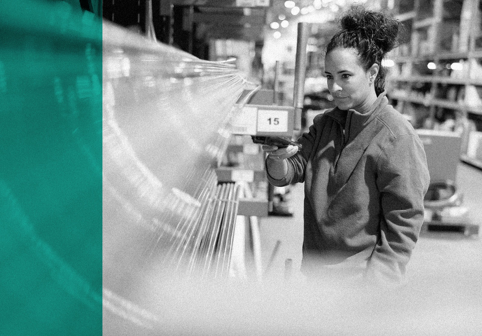 A female warehouse worker is pointing the barcode reader near copper pipes