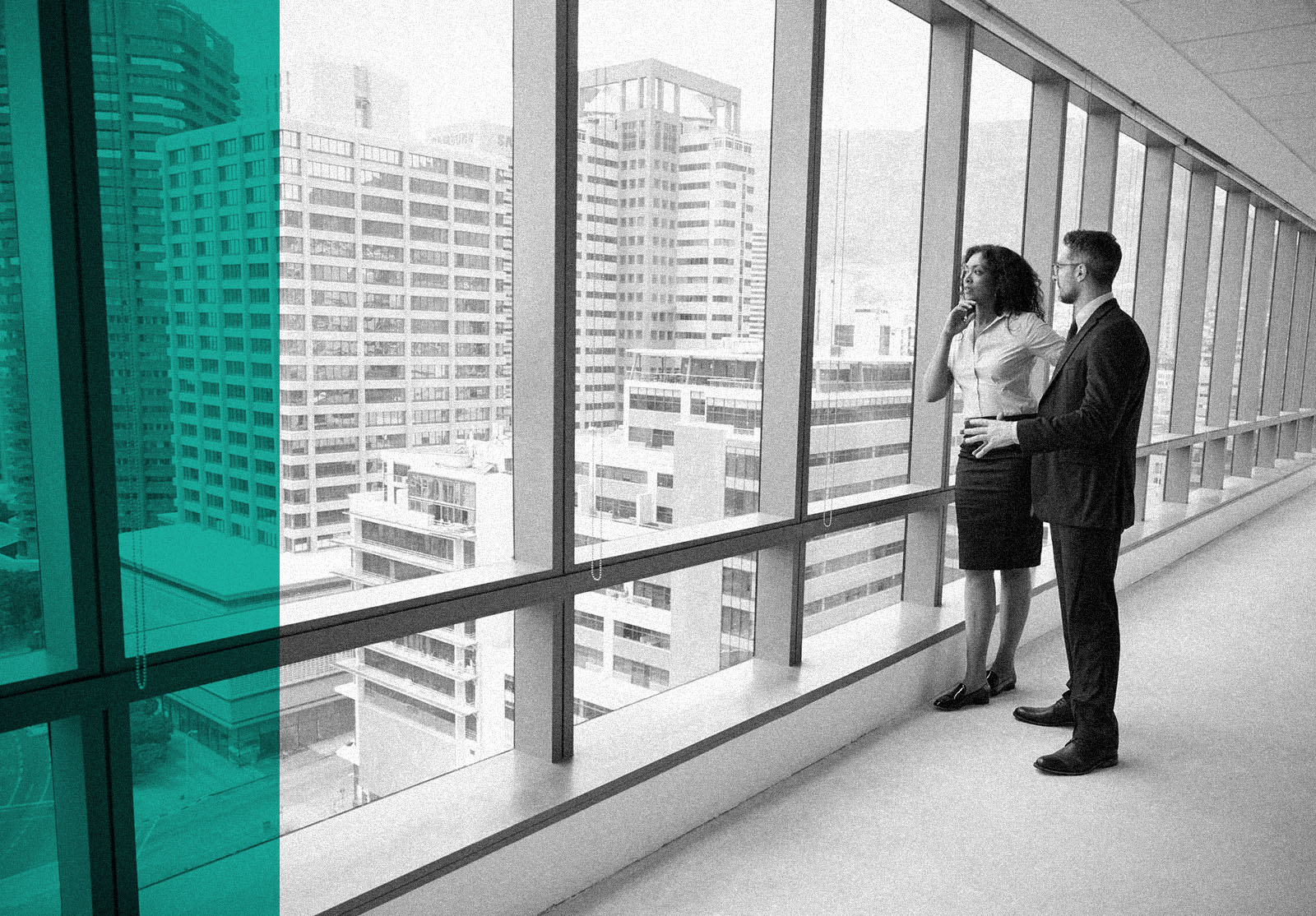 Portrait Of New Business Owners By Empty Office Window