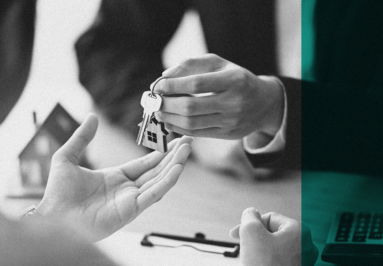 Cropped shot of House broker giving a property key to his customer while he has writing/signing on agreement at the modern wooden desk. Loan, Debt, Credit, Buying or Selling agreement concept.