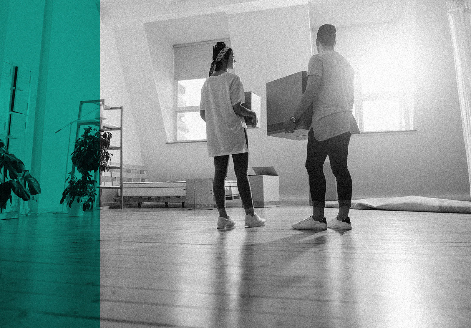 Full length rear view shot of young couple carrying cardboard box at new home. Young man and woman holding boxes and moving in new house.