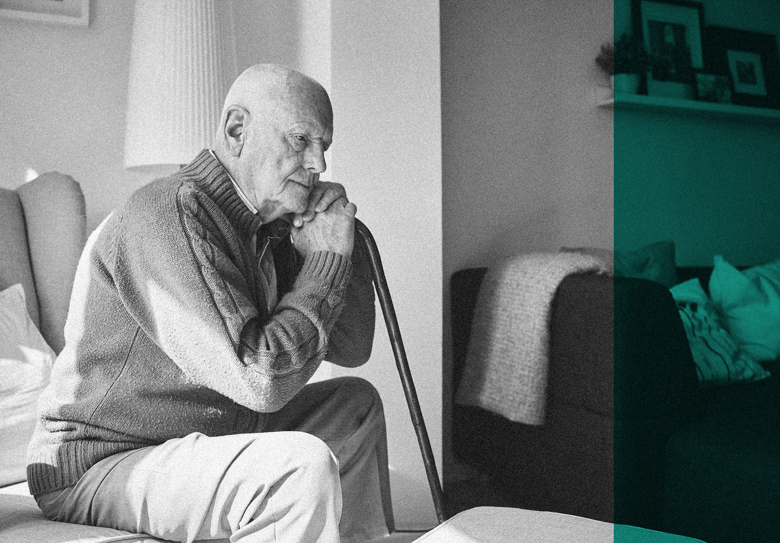 Thoughtful elderly man sitting alone at home with his walking cane