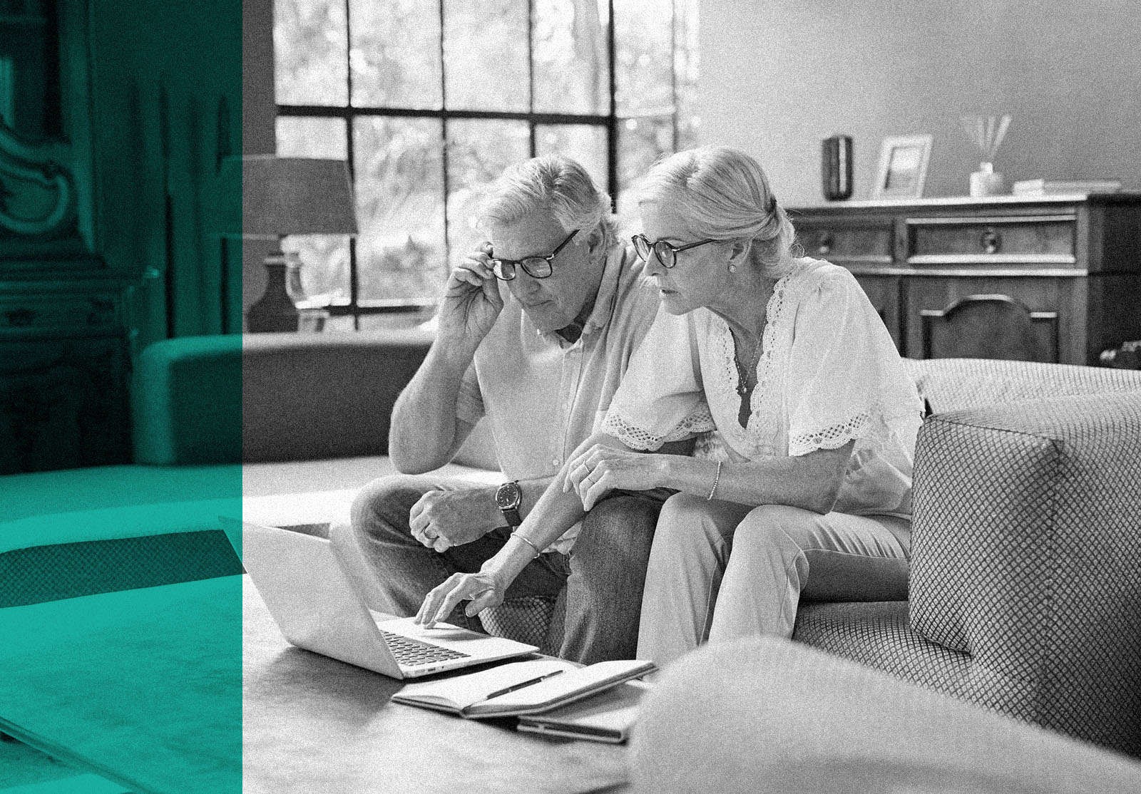 Shot of a mature couple using a laptop while calculating their finances together at home