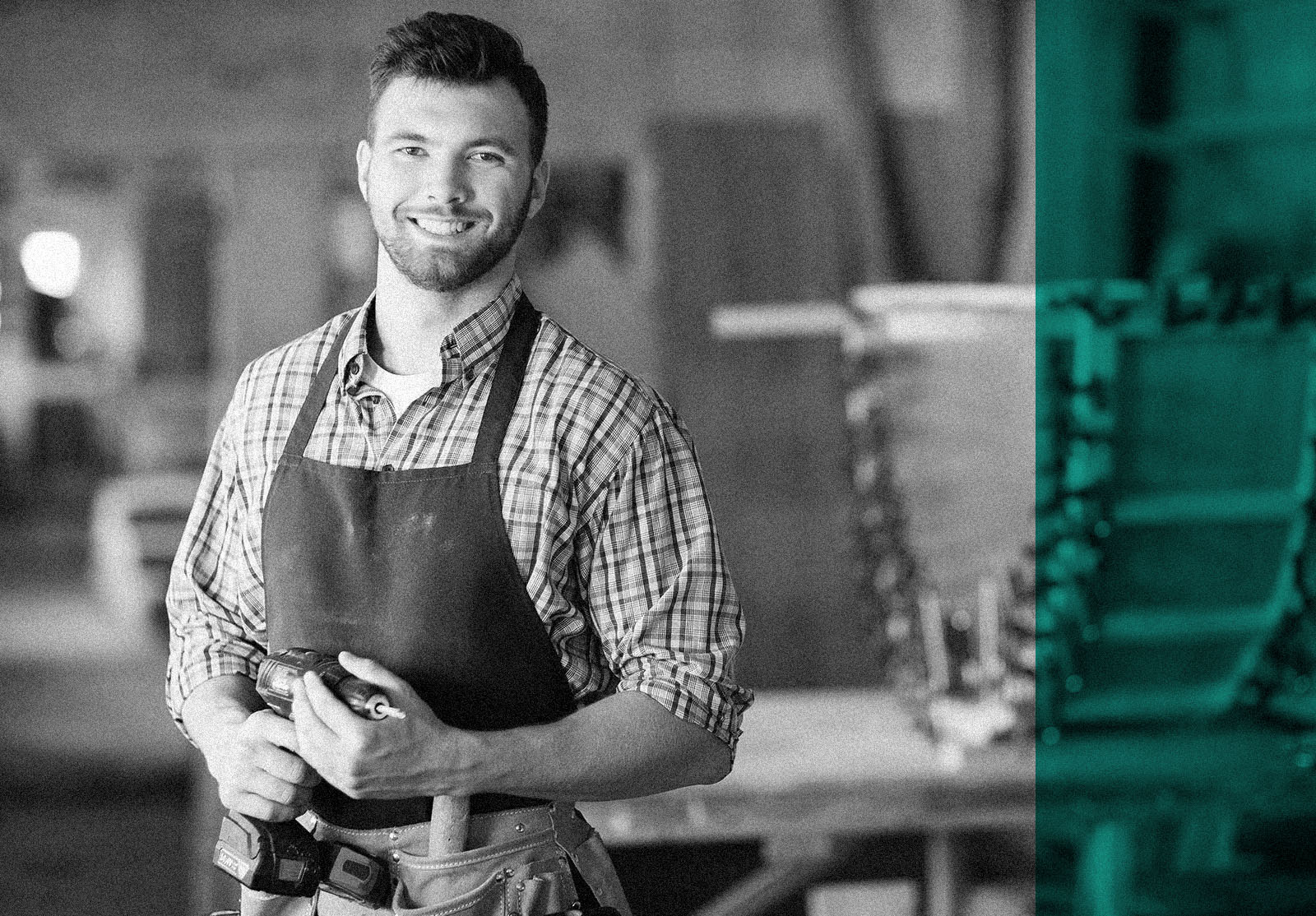 Smiling craftsman with electric drill