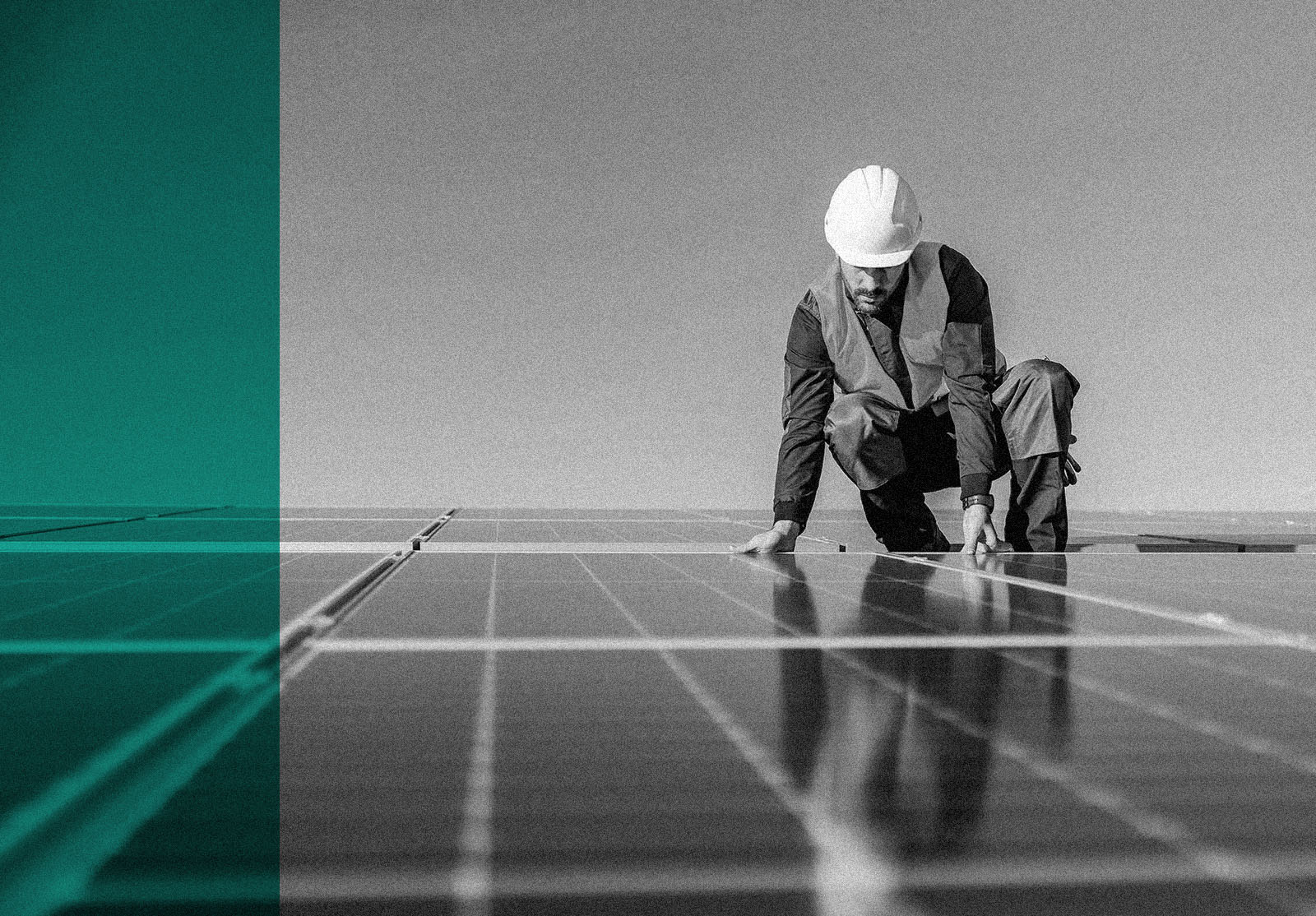 A worker installing solar panels on the roof.