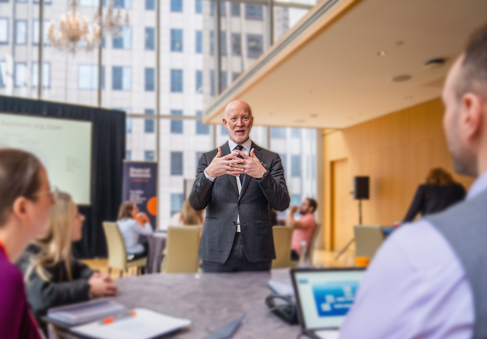 Speaker conducting a presentation in conference setting