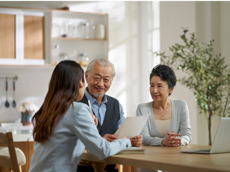 Business team in the office talking with one another around an office table.